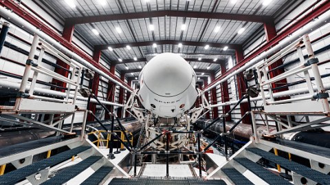 SpaceX Crew Dragon, atop the Falcon 9 rocket, inside the hangar, just before rollout to the launchpad